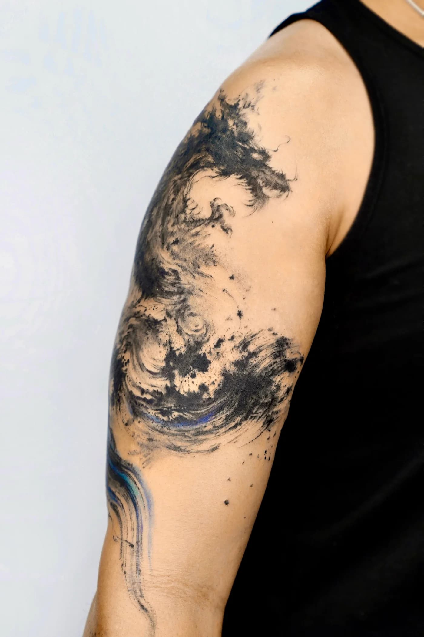 Side angle of the dragon tattoo showing the mountain body and river tail